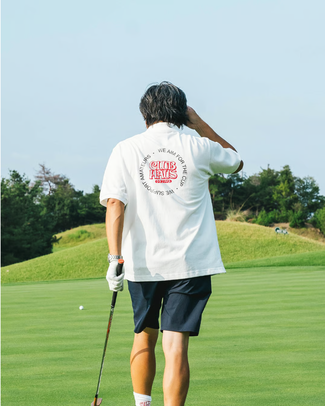 Golfer in a Clubhaus shirt on the course